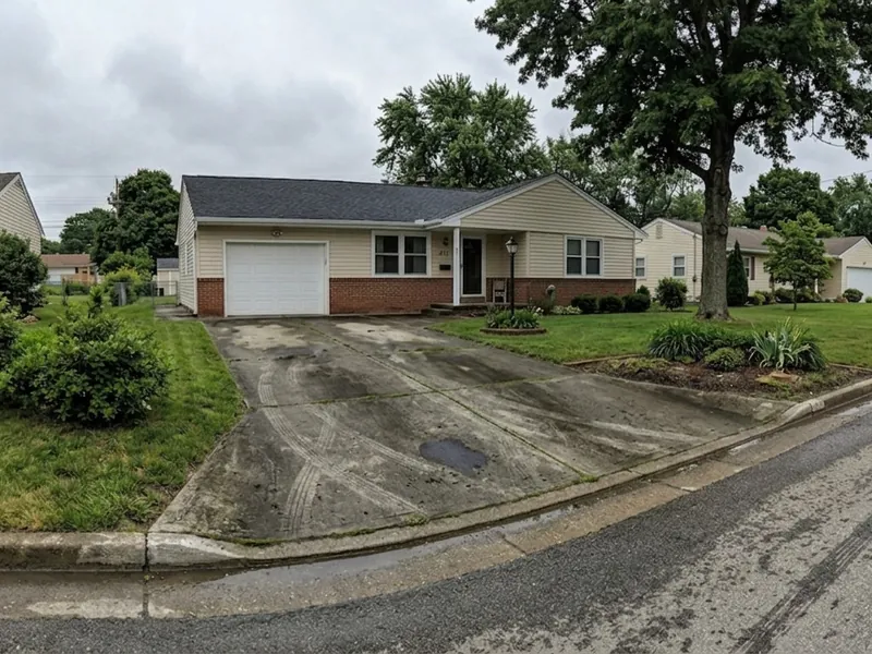 The same driveway before cleaning: grey, streaked with dirt and tyre marks.